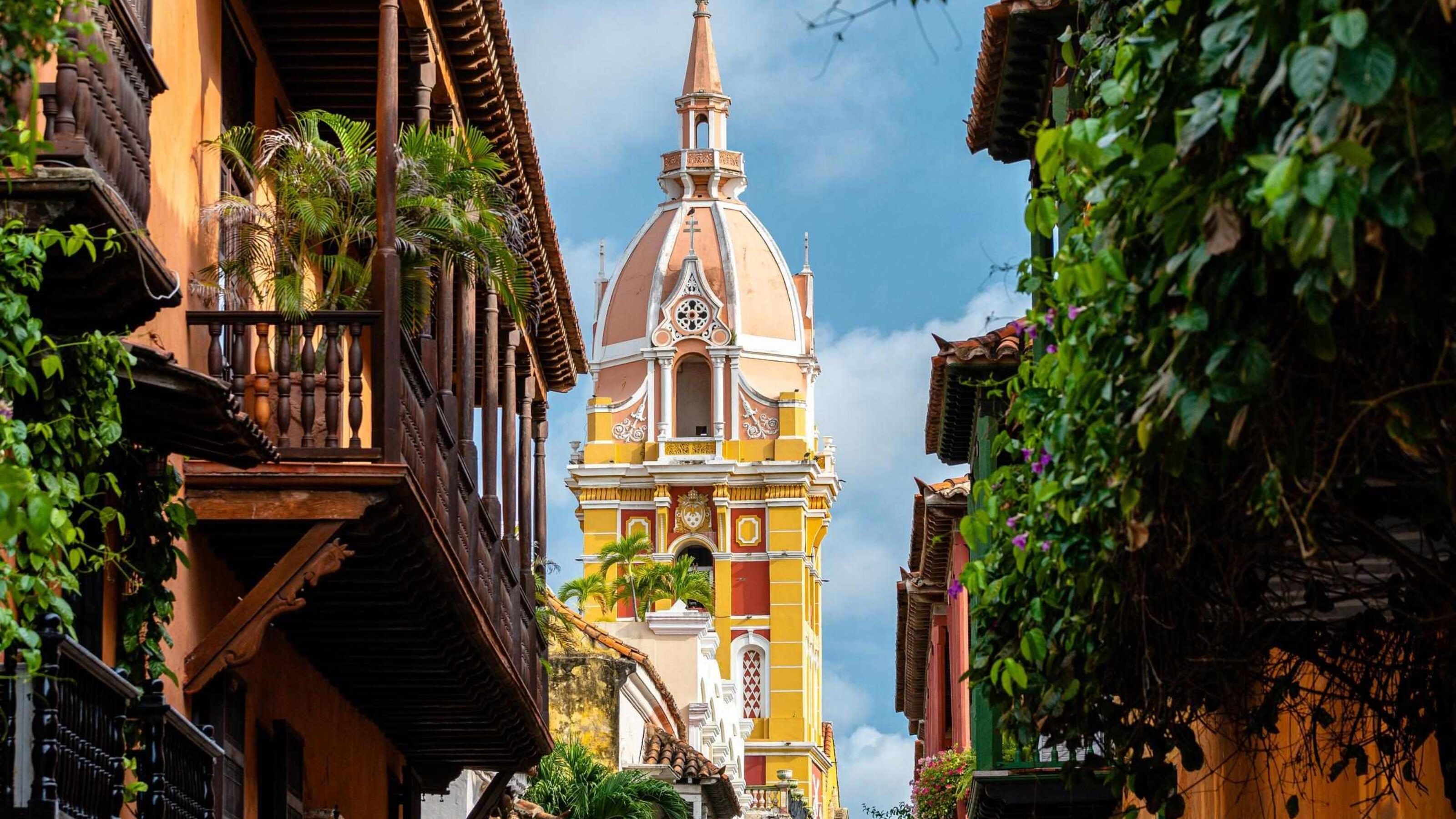The tall yellow spire of a church in Cartagena, Colombia