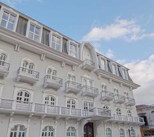 Exterior of grand hotel with balconies and large windows