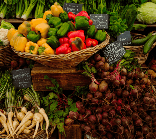 A market stall of bright and fresh vegetables.