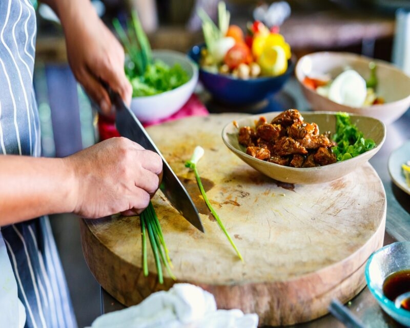 Chef making traditional cambodian meat dish at cooking class