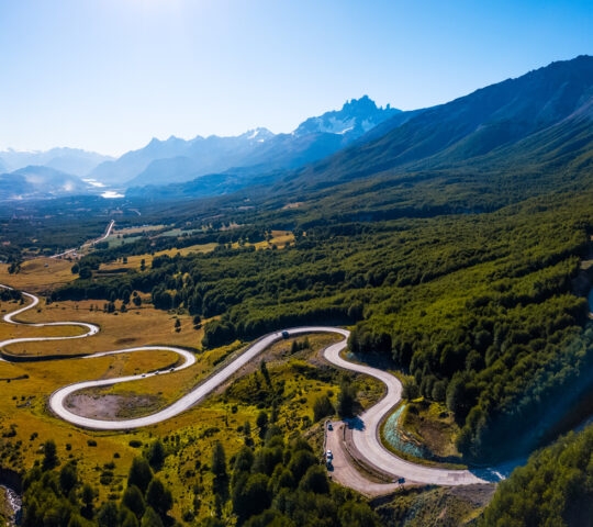 Aerial panorama of the curved asphalt road trough mountains. Carretera Austral road near the Cerro Castillo National Park. Chile