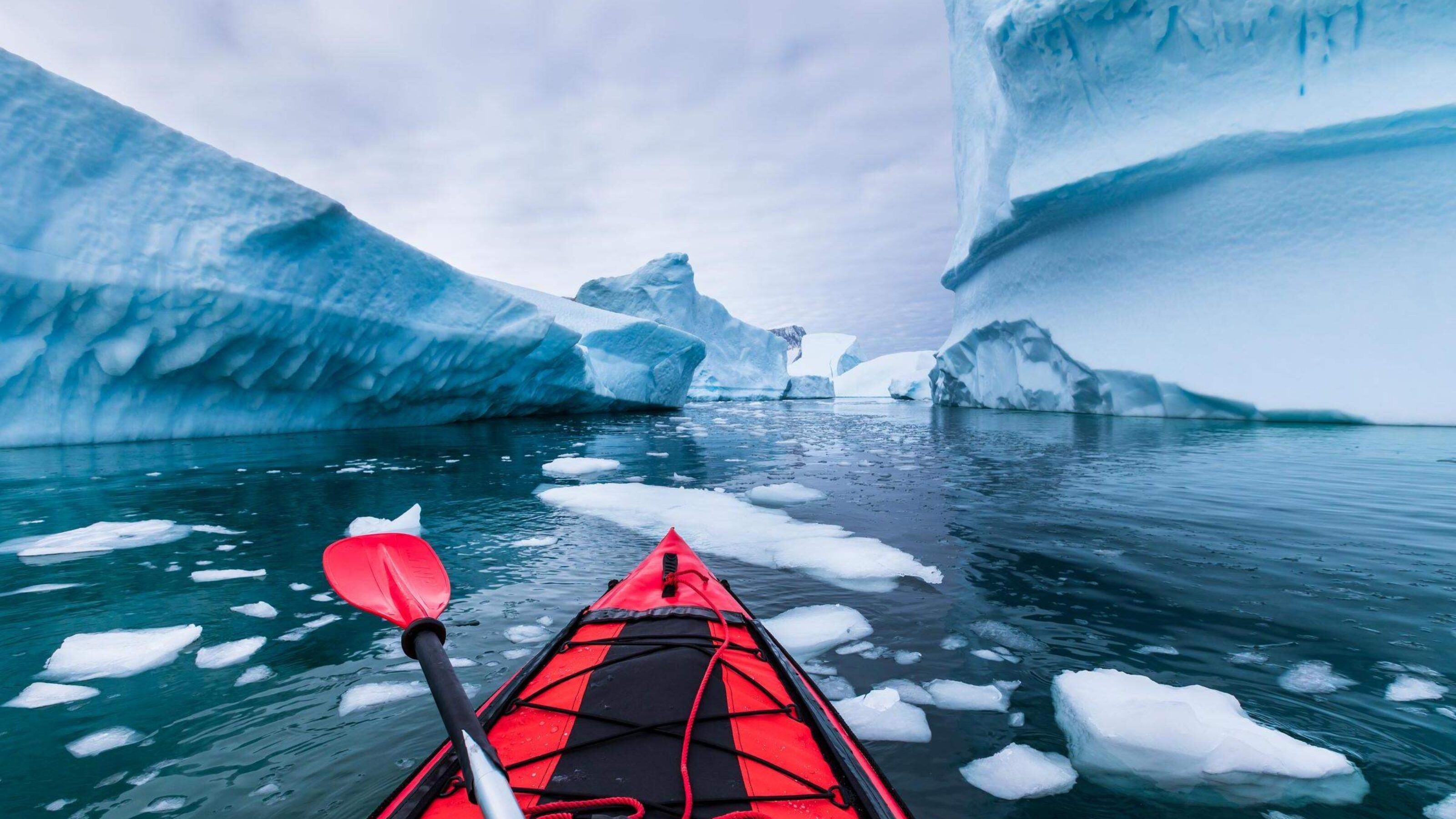 Kayaking in Antarctica between icebergs with inflatable kayak, extreme adventure in Antarctic Peninsula , beautiful pristine landscape, sea water paddling activity