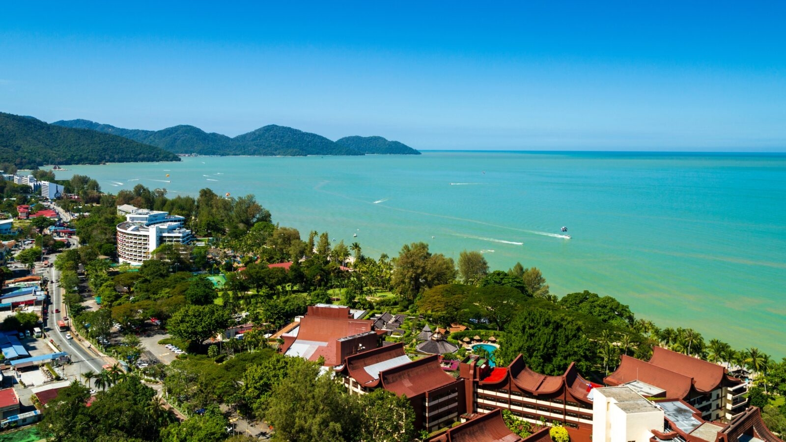 Batu Ferringhi beach on Penang Island, Malaysia with a clear blue sky in the daytime