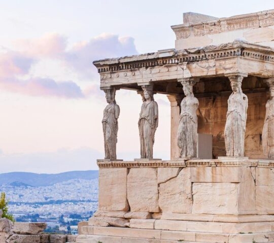 Ancient Greek Caryatids sculptures on the Erechtheion temple, Acropolis, Athens, at dusk.