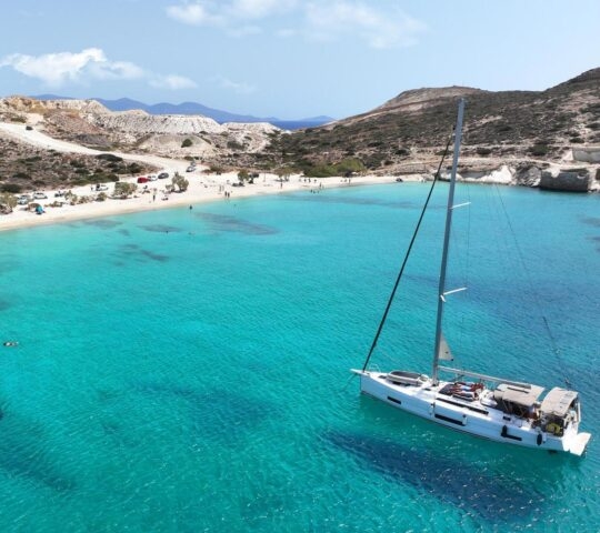 A yacht floating in the sea off Prassa beach in Kimolos, Greece
