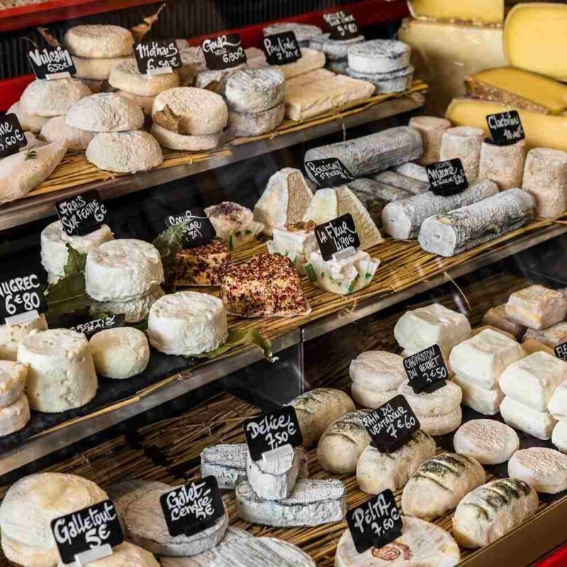 Different cheeses on display in a cheese shop
