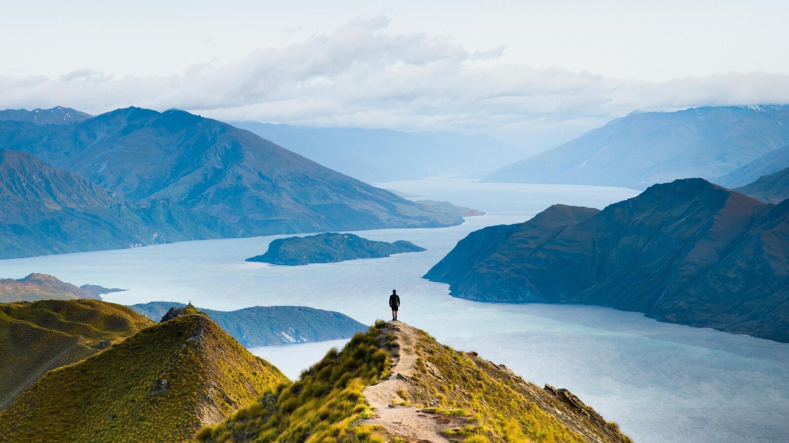 A man stood at the viewpoint from Roy's Peak in New Zealand