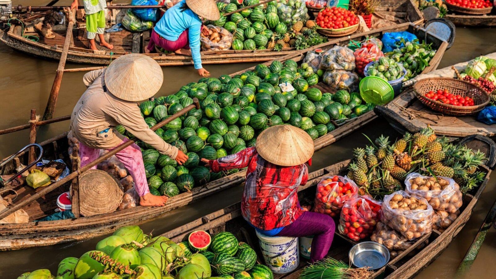 Vietnamese women selling fruit from small boats