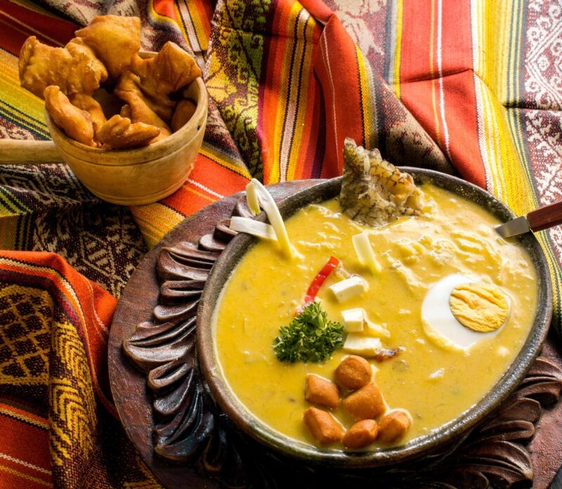Traditional bowl of Fanesca soup with egg and garnish, perfect for luxury Ecuador vacations.