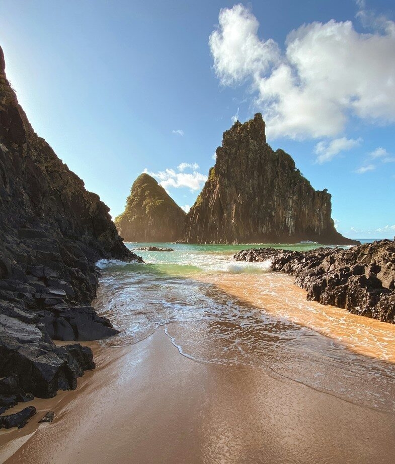 The spectacular view of Iguaçu Falls making you feel extremely small and the beaches of Fernando de Noronha during sunset.