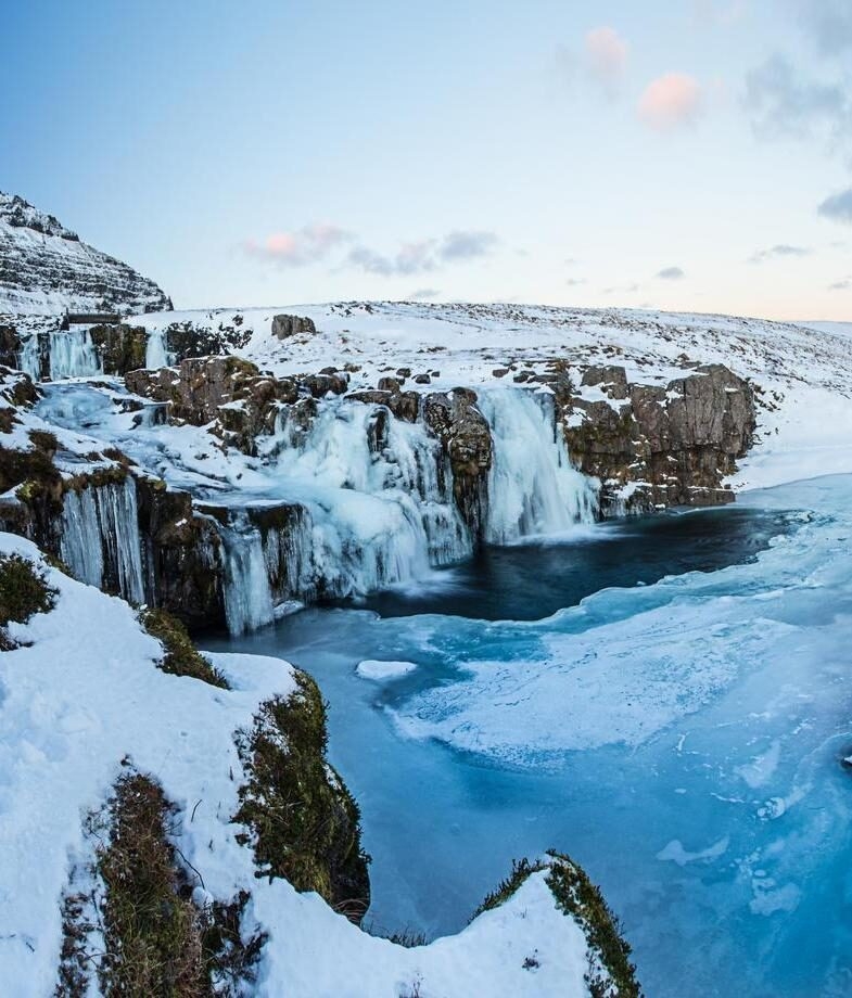 Penguins on a glacier in Antarctica, and Kirkjufell waterfall in Iceland