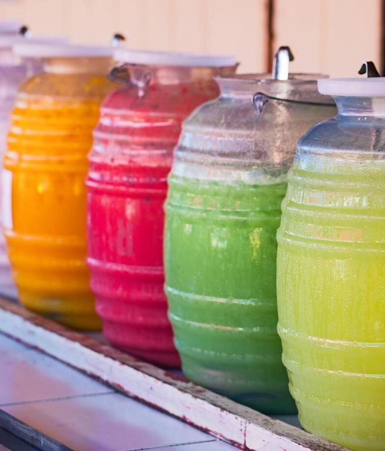 Different flavours of aguas frescas, and making tamales