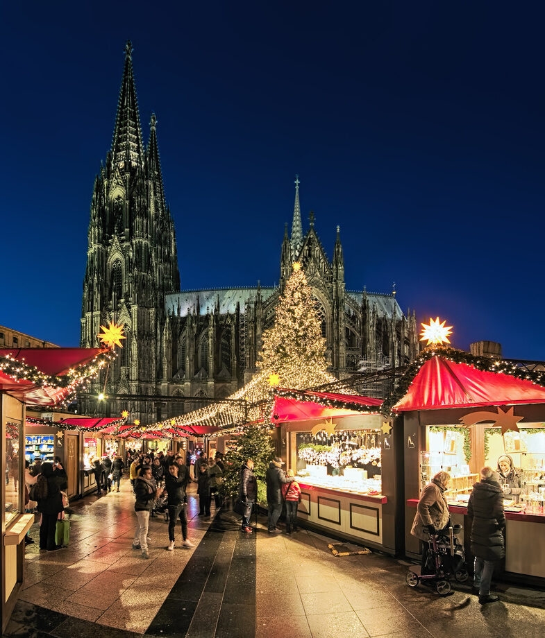 An aerial view of Salzburg’s festive celebrations, Austria, and the market in Cologne Cathedral’s square in Germany, both during Christmas.