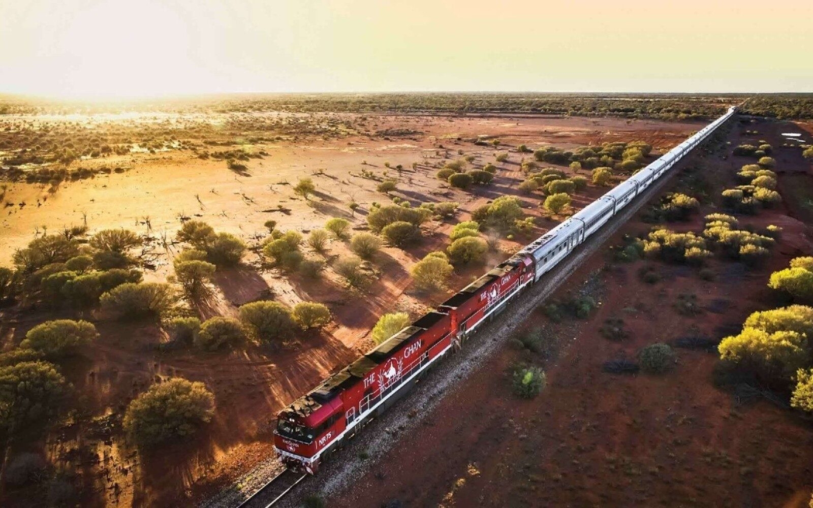 The Ghan stretching across the red desert landscapes of Australia.
