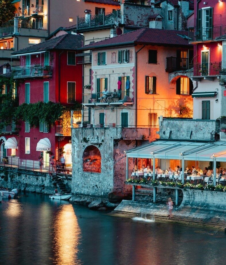 Golden light over the vineyards and rolling hills of Tuscany and a lakeside evening in Varenna with warm lights reflecting on Lake Como.