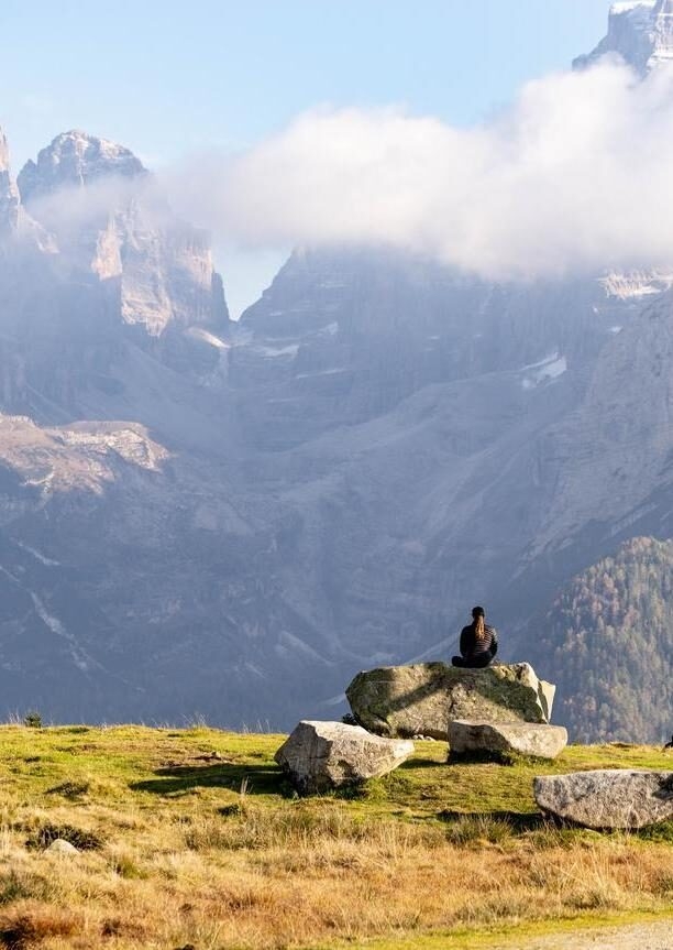 Luxury European Tours - A hiker rests on a trail across the Dolomites, Italy