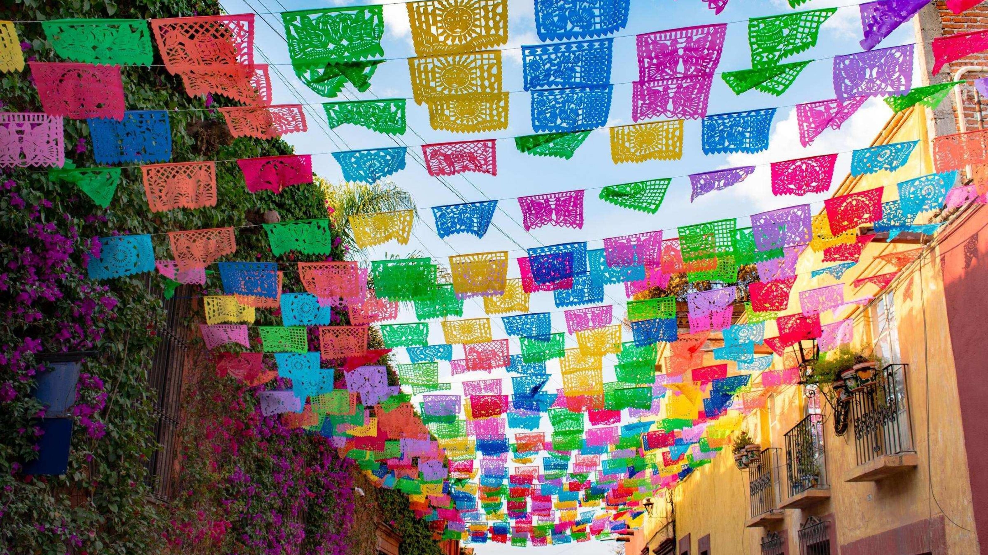 Colourful paper flags over a street in Mexico.