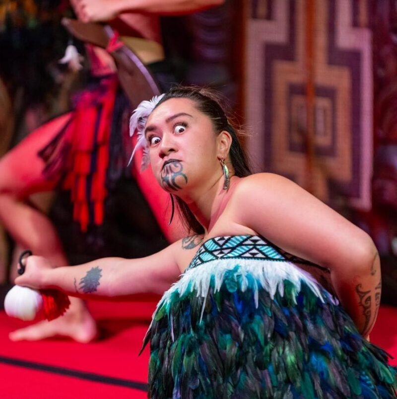 A Maori woman performing a traditional dance with a positive impact.
