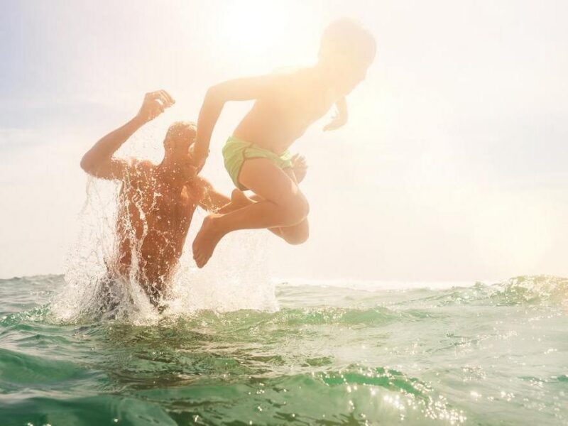 Father and son playing in water together. They cheerfully laughing when father throwing boy into sea waves water. fathers day, dad, activity, laughing, smiling, playing, active, beach, boy, caucasian, child, childhood, children, family, father, fooling, fun, happiness, happy, holiday, joy, kid, kids, leisure, lifestyle, little, maldives, male, man, ocean, outdoor, people, person, pool, resort, sea, son, splash, splash water, summer, sunny, surfing, swim, together, travel, tropic, tropical, vacation, water, young