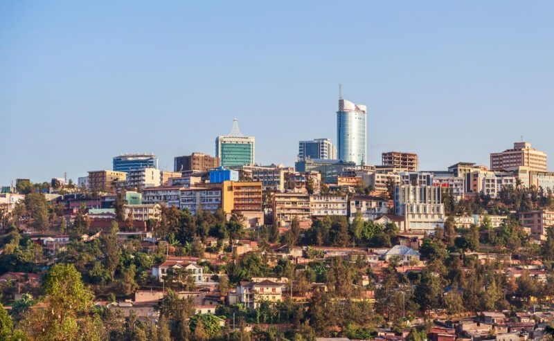 Aerial view of a dense residential neighborhood across the hilly landscape of Kigali, Rwanda.