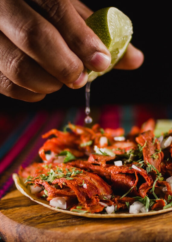 Squeezing a lime onto a Mexican street taco during a Mexico family vacation.
