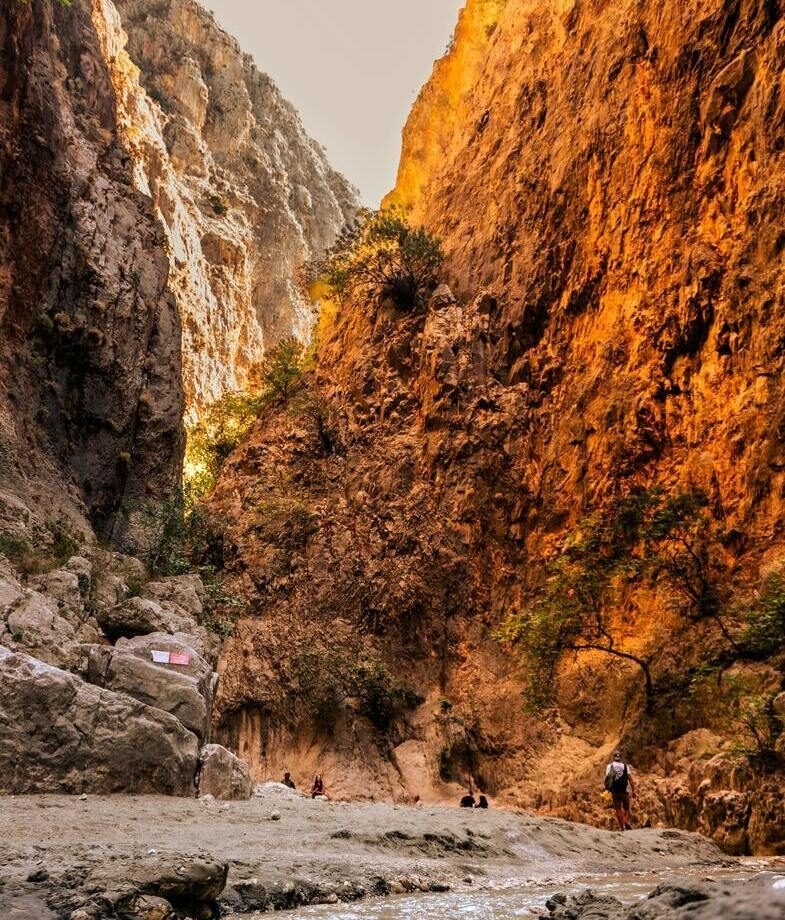 The floor of Samaria Gorge National Park in Crete, and a private boat across the turquoise waters near Corfu’s Blue Caves.