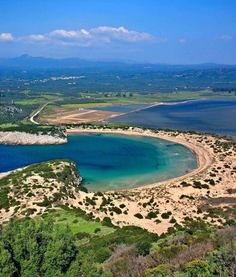 A mother and child overlooking the blue-domed churches of Oia on a family trip to Santorini, and a high-angle view of the semicircular bay of Costa Navarino.