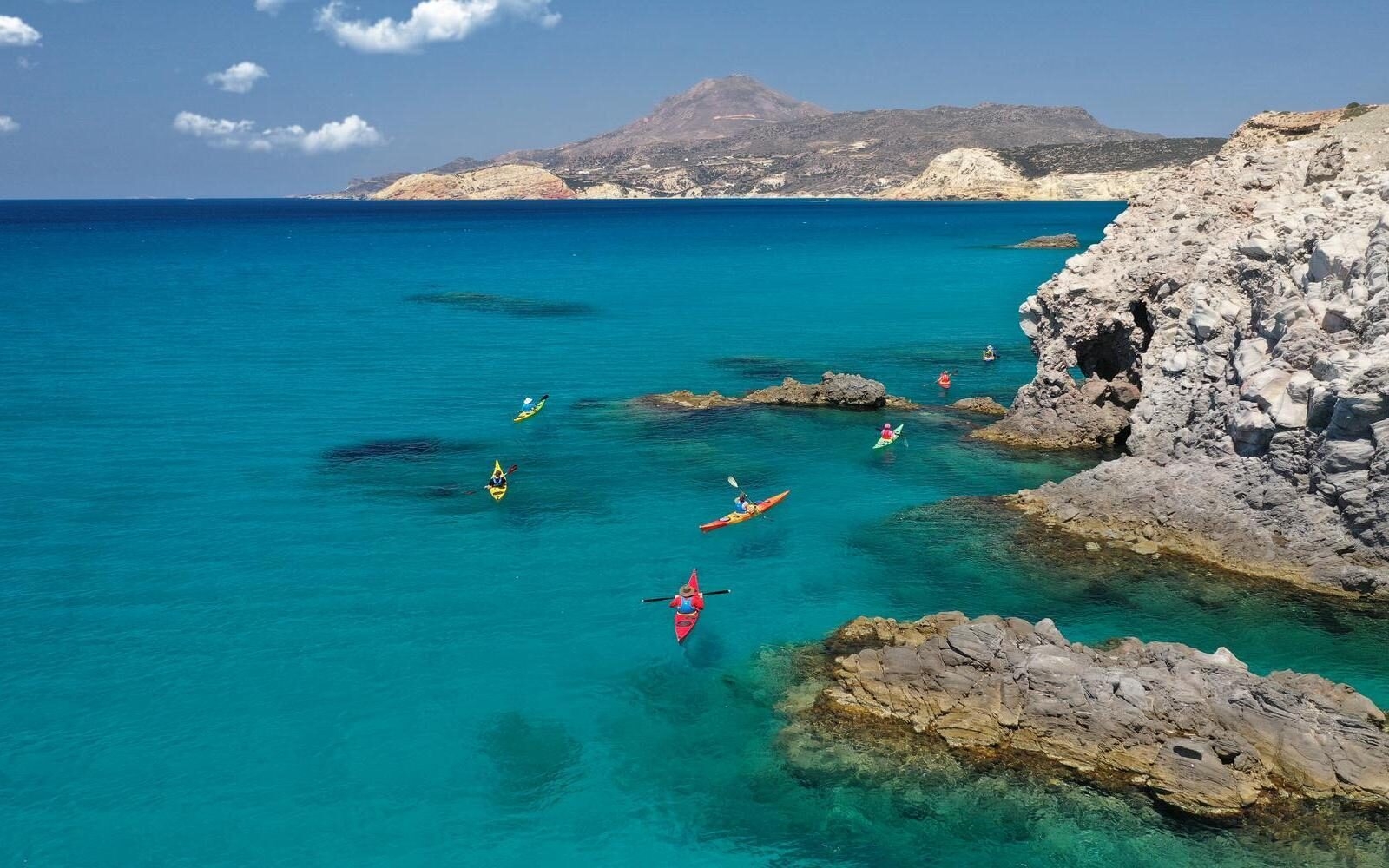 A kayaking experience through the clear blue waters off Milos, alongside the island’s rugged volcanic coastline.