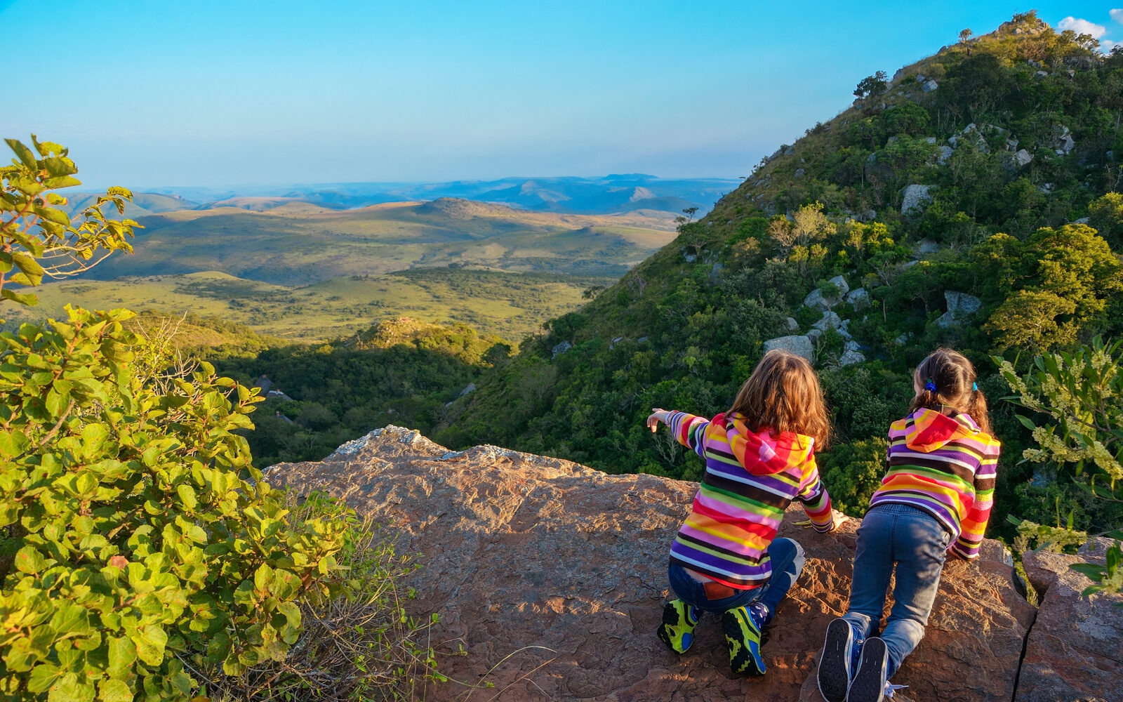 A family moment high above South Africa’s rolling mountain landscapes with wide-open views that seem to stretch on forever.