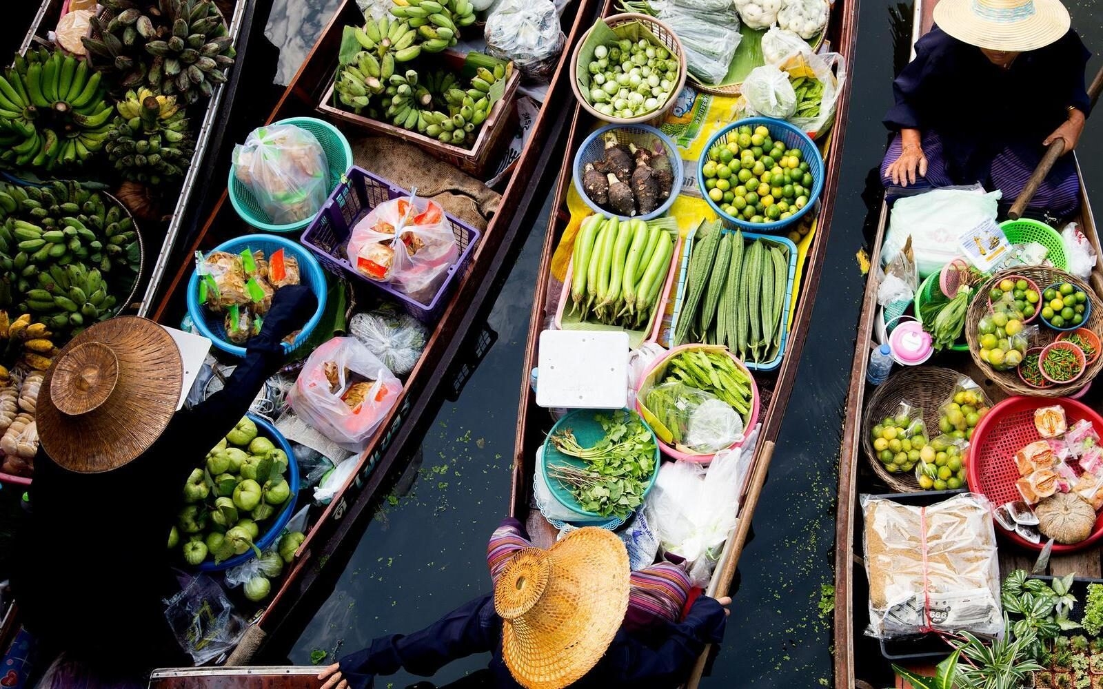 Gliding through one of Vietnam’s floating markets, where locals sell tropical fruit, fresh greens and everyday produce from boats brimming with the day’s harvest.