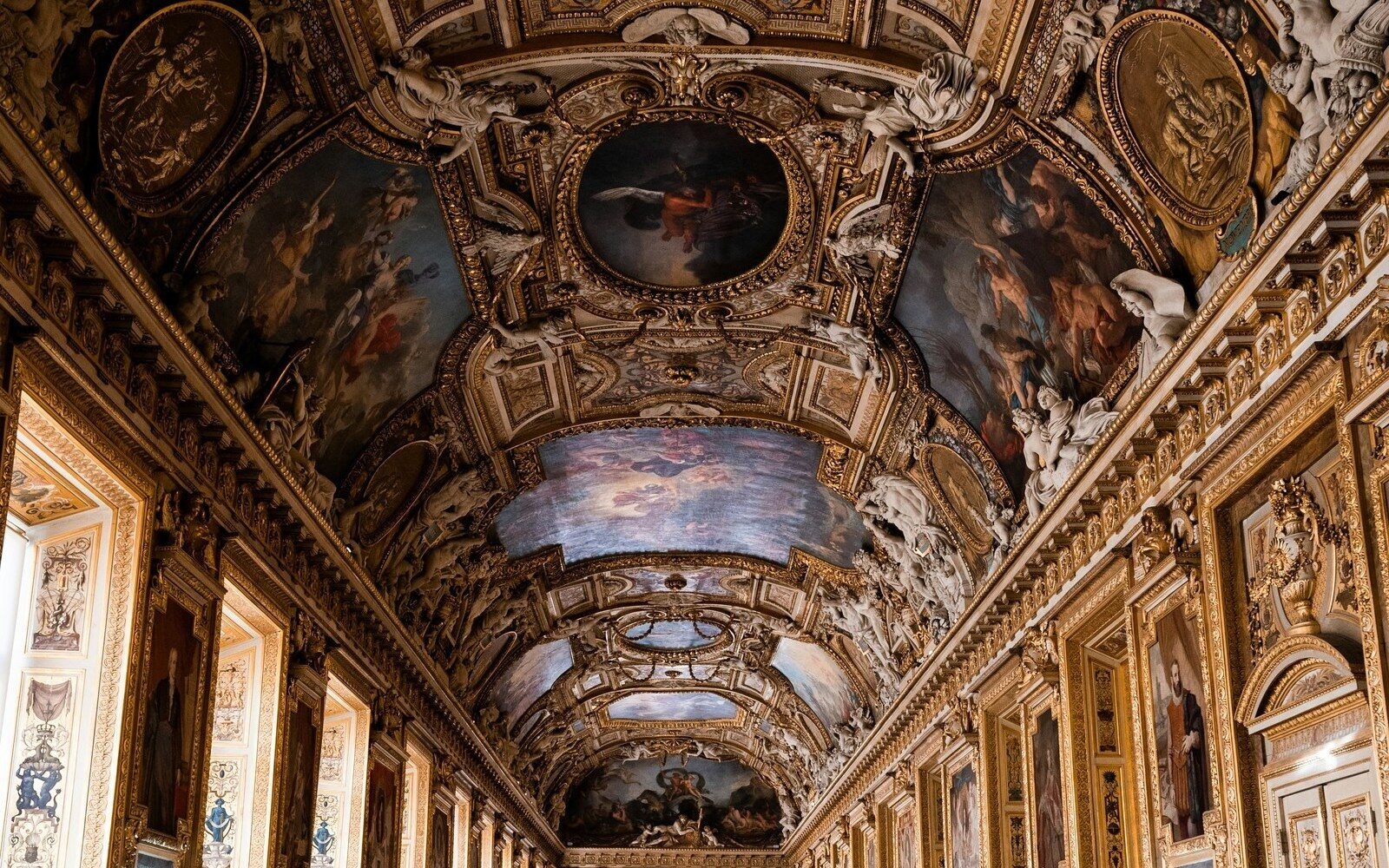 Looking up at the Louvre’s gilded ceilings with elaborate frescoes, carvings and ornate detail across every surface, as if every room were a lesson in art and history.