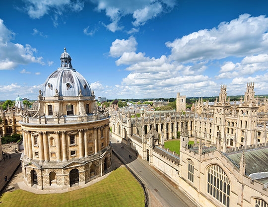 High-angle view of the domed Radcliffe Camera and Gothic university buildings in Oxford.