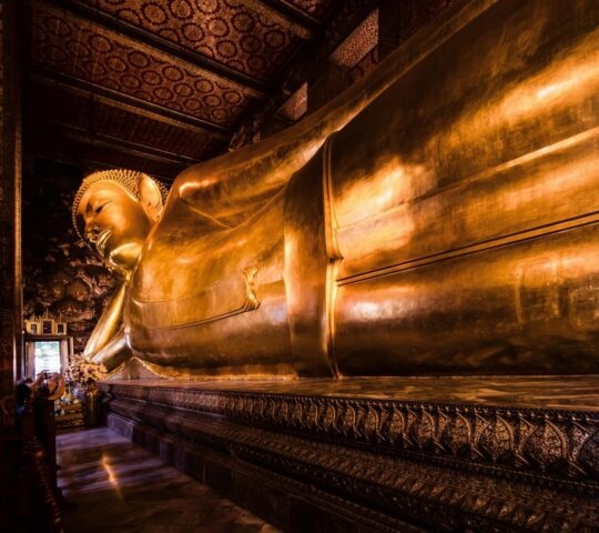 A giant golden reclining Buddha statue in Wat Pho, Bangkok