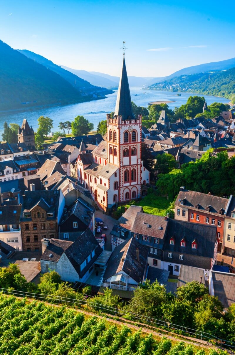 High-angle view of St. Peter's Church and historic buildings along the Rhine River in Bacharach, Germany.