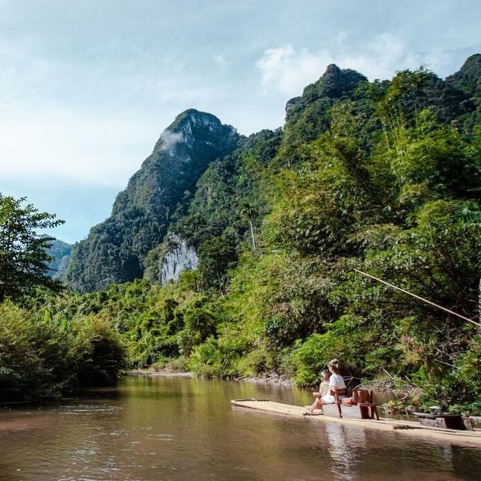 A mother and her children on a private bamboo rafting experience in Khao Sok National Park.