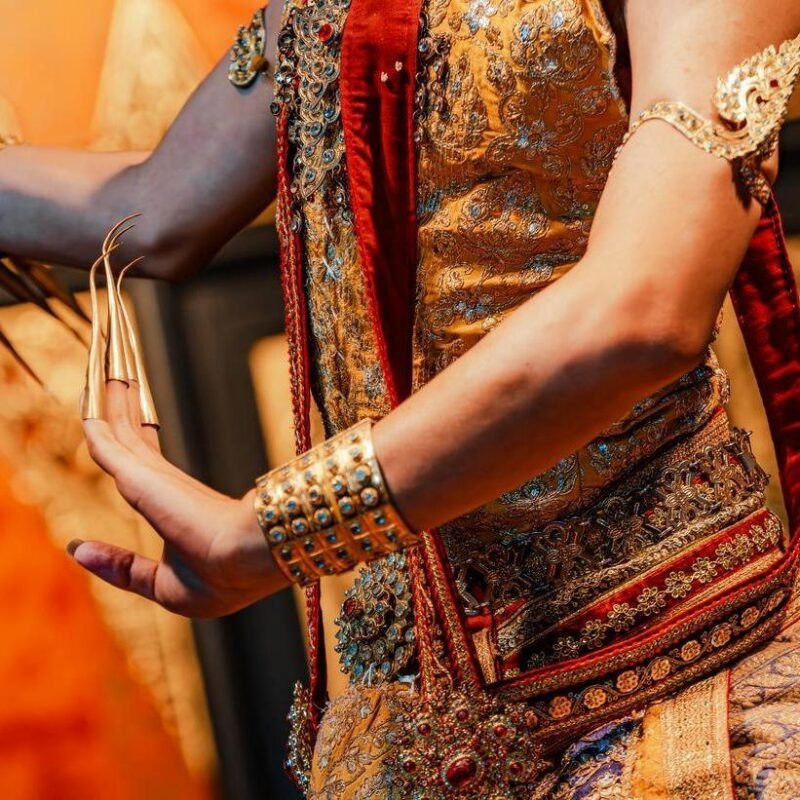 A traditional Thai dancer with a close up off the clothing and accessories.