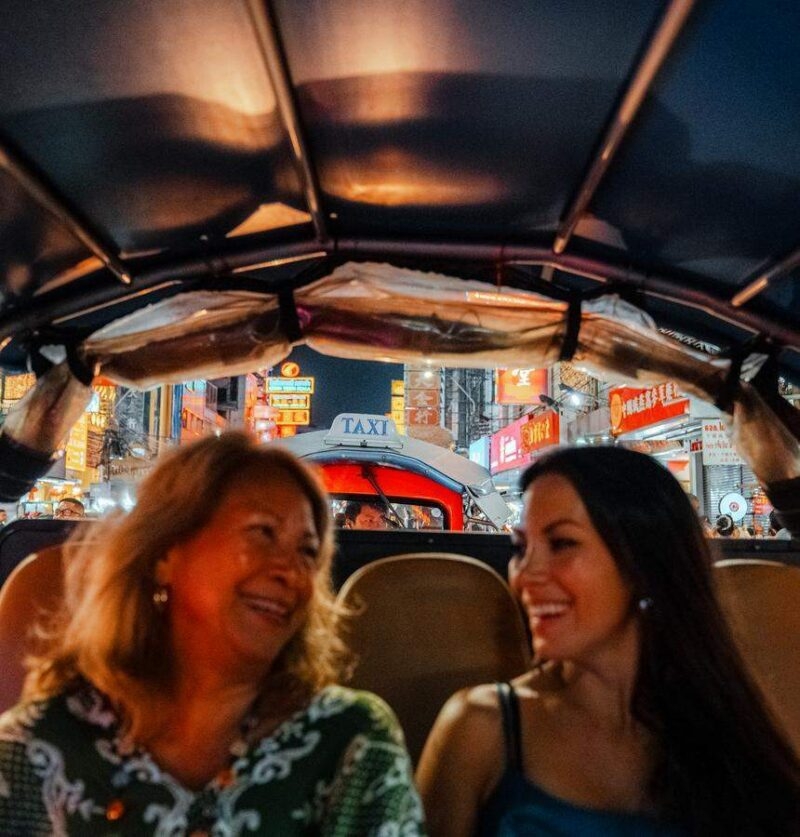 A mother and daughter enjoy exploring Bangkok's Chinatown in a private tuk tuk experience.