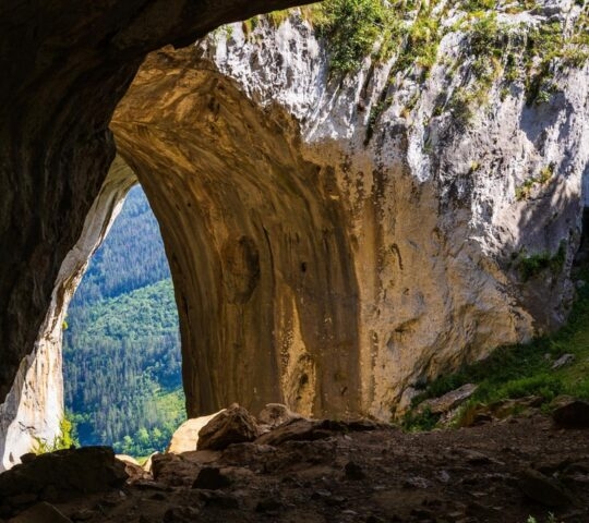 A view from inside the Eye of Aitzulo, Geological Formation in Aizkorri-Aratz Natural Park looking at green forests.