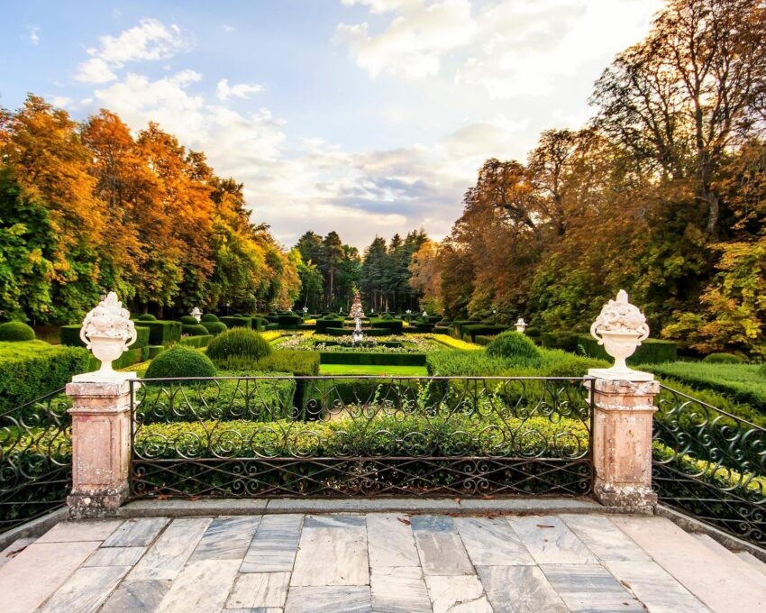 A terrace overlooking the formal landscaped gardens and autumn trees at La Granja de San Ildefonso.