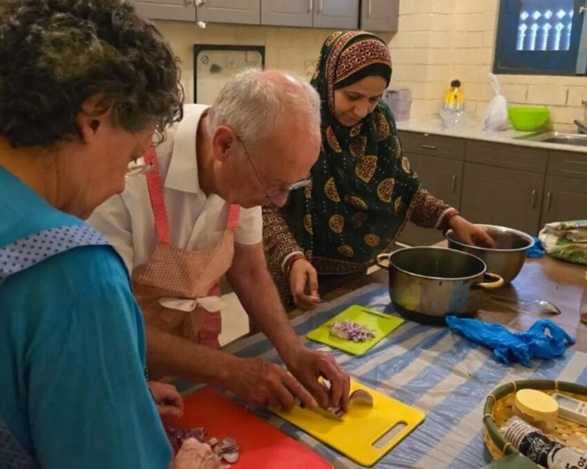 A couple taking part in a cooking class as part of an Omani culture experience