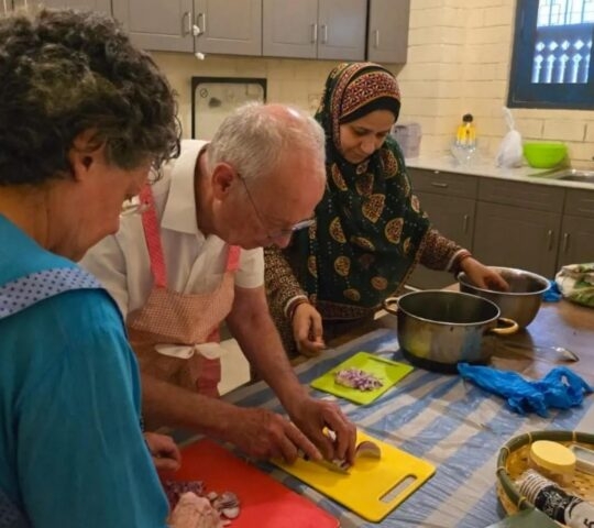 A couple taking part in a cooking class as part of an Omani culture experience