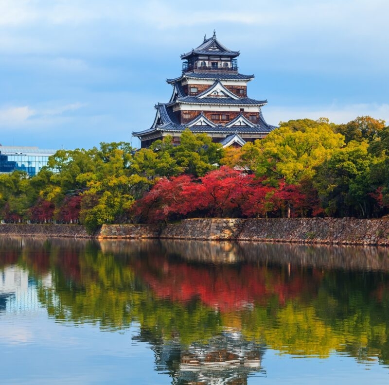 Hiroshima castle on the side of Otagawa river in autumn