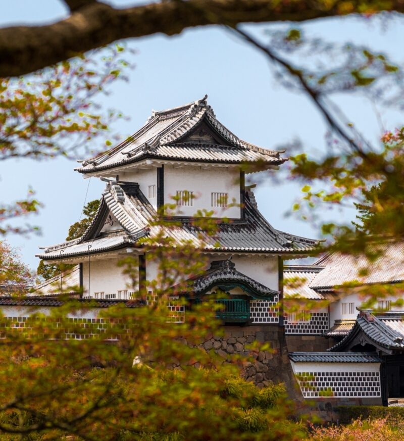 Kanazawa castle seen through autumn leaves in Japan
